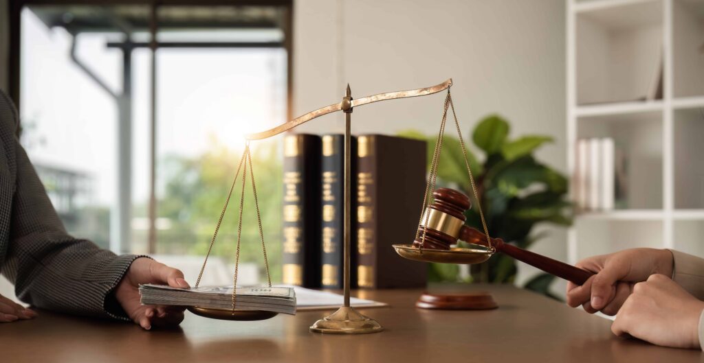 Scales of justice balancing cash and a judge’s gavel, symbolizing legal settlement, compensation, and personal injury claim negotiations. Scales of justice balancing cash and a judge’s gavel, symbolizing legal settlement, compensation, and personal injury claim negotiations.