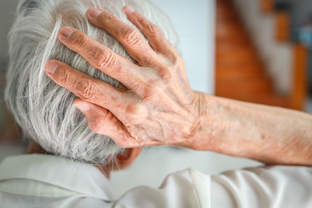 Person holding the back of their head after suffering a brain injury in Columbus