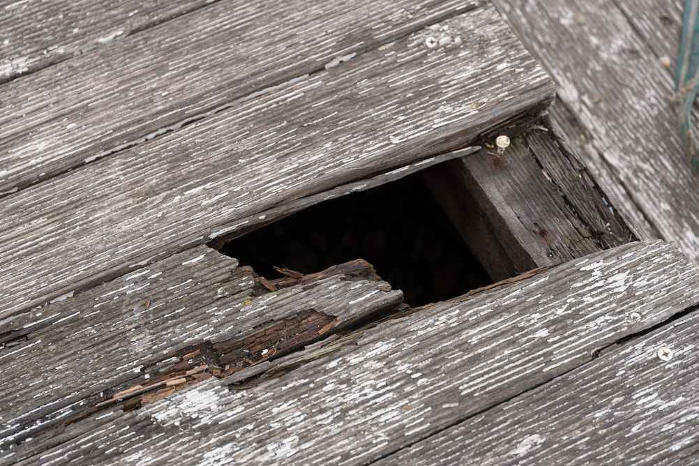 Broken wooden decking showing unsafe property conditions in Columbus