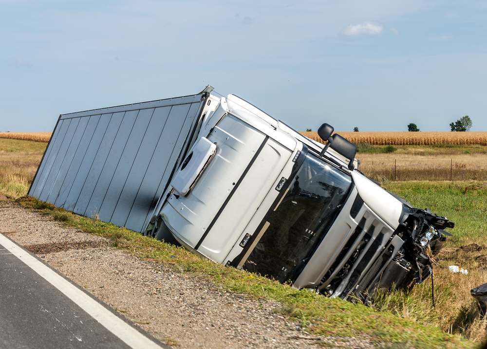 Overturned semi-truck in a ditch after a rollover accident near Columbus