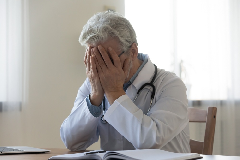 Doctor holding his head in his hands, reflecting a medical negligence case in Columbus