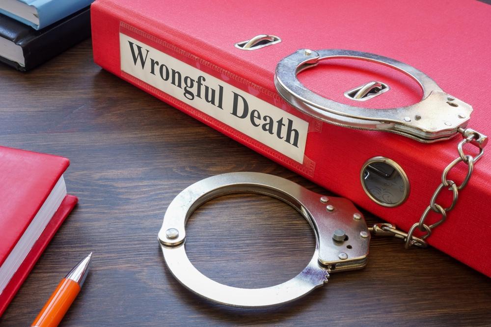 Wrongful death case file and handcuffs representing a Mississippi legal claim